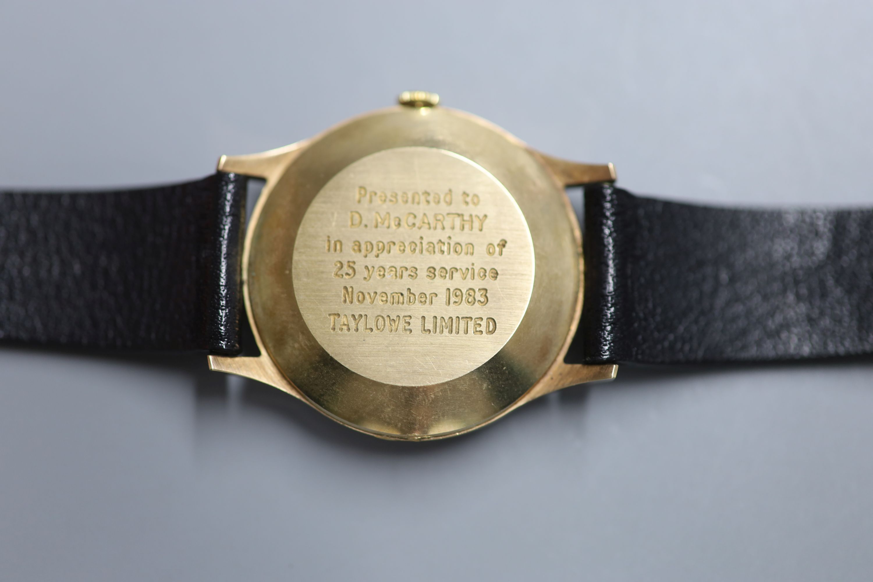 A gentlemans 1980s yellow metal automatic wrist watch, retailed by Garrard, with case back inscription,